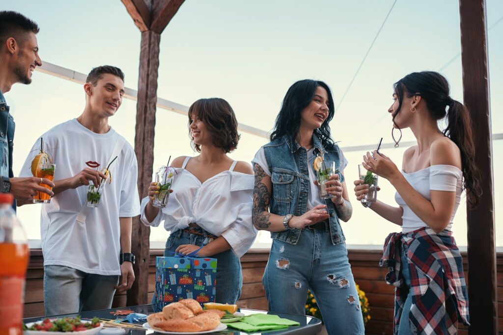 Cheerful young people chatting at a rooftop party